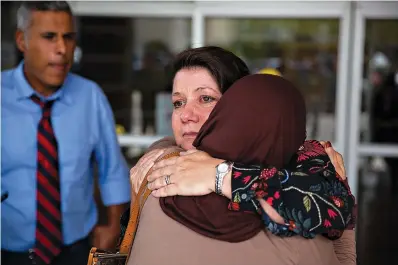  ?? Matthew Westmorela­nd/ The Victoria Advocate via AP ?? left Susannah Porr hugs Victoria Islamic Center member Darakhshan Hashmi on July 16 after Marq Vincent Perez was convicted of federal arson and explosives charges and of a hate crime charge at the Martin Luther King, Jr., Federal Building in Victoria,...