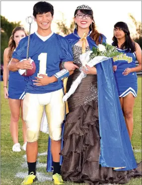  ?? Photo by Mike Eckels ?? The 2016 Decatur Homecoming king and queen, Leng Lee and Shaney Lee, stand before the crowd during their coronation Oct. 21 at Bulldog Stadium in Decatur. By Mike Eckels meckels@nwadg.com