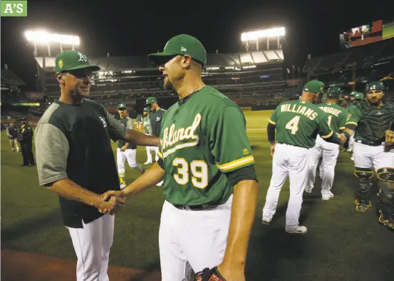  ?? Michael Zagaris / Getty Images ?? A’s manager Bob Melvin, shown shaking hands with closer Blake Treinen, grew up on the Peninsula, played for Cal and the Giants, and truly loves Oakland.