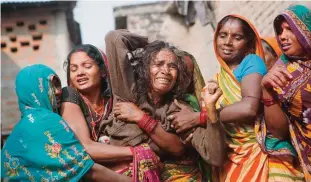  ?? —AP ?? SAPTARI DISTRICT, Nepal: In this Wednesday, Nov 23, 2016 photo, a woman breaks down after seeing the body of her son Balkisun Mandal Khatwe, a migrant worker who died in his sleep in Qatar, at Belhi village.