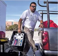  ?? JAE C. HONG/THE ASSOCIATED PRESS ?? Armando Olvera, 49, gives out rolls of toilet paper to homeless people Dec. 2 while operating a shower trailer on the Santa Ana River trail in Anaheim, Calif.