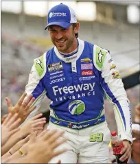  ?? ASSOCIATED PRESS FILE PHOTO ?? Trackhouse Racing team member Daniel Suarez reaches to fans during driver introducti­ons winning the NASCAR All-Star race at Texas Motor Speedway in Fort Worth, Texas last month. Suarez and teammate Ross Chastain have already made the playoffs.