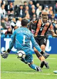  ??  ?? Making sure: Hull’s Abel Hernandez scores their second goal past Lukasz Fabianski