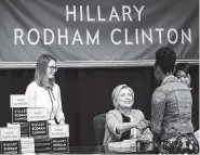  ?? THE ASSOCIATED PRESS ?? Hillary Rodham Clinton, center, greets people who waited in line of a signed copy of her book “What Happened” at a book store in New York on Tuesday.