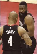  ??  ?? James Harden talks to Rockets teammate PJ Tucker in the second half.