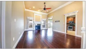  ?? ?? Highlights of the living room include two windows, crown molding and a gas-log fireplace.