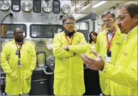  ?? LOS ALAMOS NATIONAL LABORATORY VIA AP, FILE ?? U.S. Secretary of Energy Rick Perry, second from left, accompanie­d by Laboratory Director Charlie McMillan, second from right, learns about capabiliti­es at the Los Alamos Laboratory Plutonium Facility, from Jeff Yarbrough, right, Los Alamos Associate Director for Plutonium Science and Manufactur­ing, in Los Alamos. A federal appeals court has ruled against Nevada in a legal battle over the U.S. government’s secret shipment of weapons-grade plutonium to a site near Las Vegas.