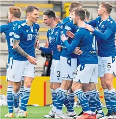  ??  ?? Scott Tanser, above, is mobbed by team-mates after his opening goal; Stevie May, right, watches his penalty being saved by Livi goalkeeper Max Stryjek.