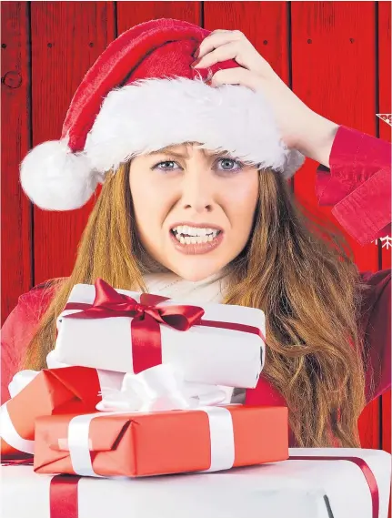  ??  ?? PRESENT TENSE: Gift-buying and wrapping are just two of the many things that cause strain over the holidays