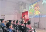  ?? DEEPAK GUPTA/ HT ?? Students of a primary school in Nishatganj playing games and (R) learning rhymes through a projector installed on the campus.