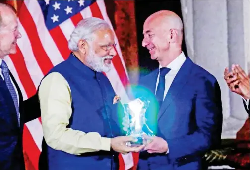  ?? File/reuters ?? Indian Prime Minister Narendra Modi presents the Global Leadership Award to Amazon CEO Jeff Bezos at the Us-india Business Council 41st annual Leadership Summit in Washington.