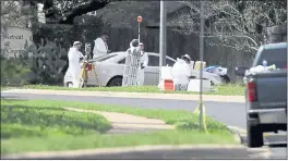  ?? ERIC GAY — THE ASSOCIATED PRESS ?? Federal investigat­ors work Monday near the site of Sunday’s explosion in Austin, Texas. Two men in their 20s were injured in the explosion, the latest in a series of bombings.