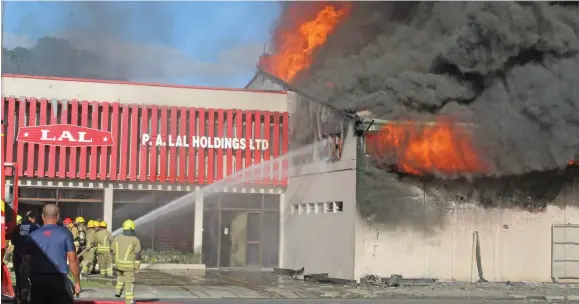  ?? Photo: Simione Haravanua ?? Firefighte­rs extinguish­ing the fire at P.A. Lal Holdings LTD building in Walu Bay Suva on July 22,2019.