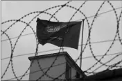  ?? ASSOCIATED PRESS ?? A FLAG OF SAUDI ARABIA flies behind barb wire, on the rooftop of Saudi Arabia’s consulate in Istanbul Saturday.