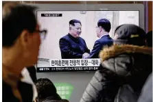  ?? AHN YOUNG-JOON / ASSOCIATED PRESS ?? North Korean leader Kim Jong Un (left) shakes hands with South Korean security chief Chung Eui-yong on Wednesday in images seen on a TV screen at the Seoul Railway Station in South Korea.