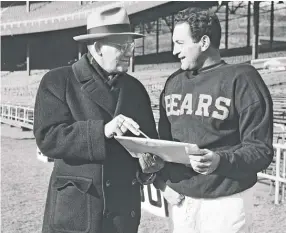  ??  ?? Bears coach George Halas talks with quarterbac­k Sid Luckman at the Polo Grounds in New York in 1946.