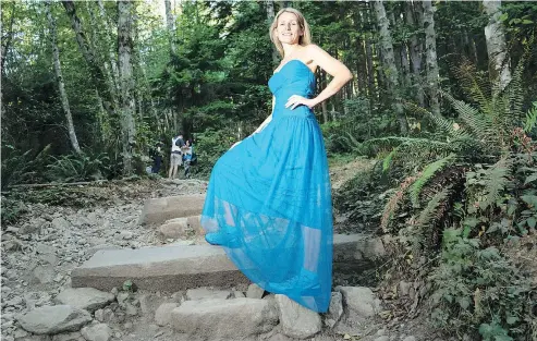  ?? RICHARD LAM/PNG ?? Karen Stark shows off the gown she will be wearing while climbing the Grouse Grind when she and nine friends hit the trail on Sept. 29. They’re looking for two more $1,000 sponsors for their KidSport fundraiser.