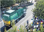  ??  ?? Thanks to the Make-A-Wish Foundation, 6-yearold Ethan Dean got to experience what it’s like to be a garbage truck driver, riding in a real garbage truck through downtown Sacramento on Tuesday.