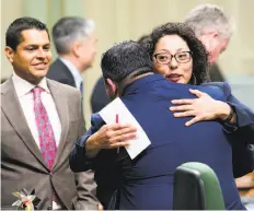  ?? Rich Pedroncell­i / Associated Press ?? Democratic Assembly members Eduardo Garcia of Coachella (Riverside County) and Cristina Garcia of Bell Gardens (Los Angeles County) hug last Monday after their climate change bills were approved.