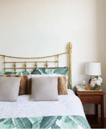  ??  ?? BEDROOMS Fur cushions from We’ar provide an interestin­g contrast to the leafy bedlinen (from Spotlight) in the guest bedroom. Harriet’s soft pink bedlinen and a pretty canopy (both from Harvey Norman) hung with tassels chime softly with the curtains...