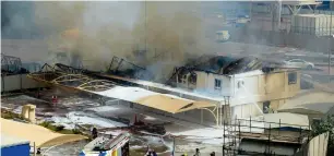  ?? — Photo by Neeraj Murali ?? Firefighte­rs putting off the blaze at a constructi­on site near the Sheikh Zayed Road on Saturday. A Dubai Civil Defence official said nobody was injured in the accident.