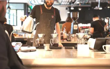 ??  ?? Matt Topping makes pour-over coffee at La Marzocco’s cafe and showroom in Seattle.