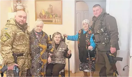  ?? ?? Maria Stasenko, second from right, stands next to her grandson, preparing to fight with Ukrainian forces.