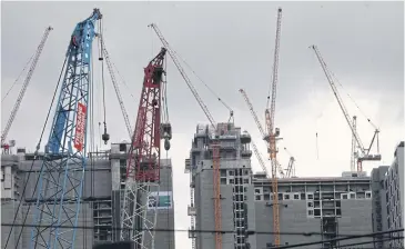  ?? APICHART JINAKUL ?? High-rise buildings under constructi­on in Bangkok. Constructi­on prices have dropped 10-15%.