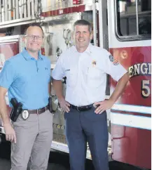  ?? [PHOTO PROVIDED BY MELINDA INFANTE] ?? Edmond Police Chief J.D. Younger, left, and Edmond Fire Chief Chris Goodwin are settling down in their new posts and using each other as a mini-support system.