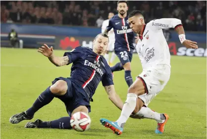  ??  ?? FRANCE: Paris Saint Germain’s Zlatan Ibrahimovi­c (left) vies for the ball with Nice’s Llyod Palun during their League One soccer match, at Parc des Princes stadium. — AP