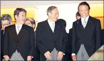  ??  ?? Newly elected Japanese Prime Minister Yoshihide Suga (center), smiles with Finance Minister Taro Aso (right), and Foreign Minister Toshimitsu Motegi (left), as they go for a photo session after their first cabinet meeting
at the prime minister’s official residence in Tokyo on Sept 16. (AP)