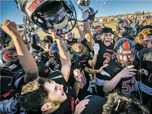  ?? JIM WEBER/THE NEW MEXICAN ?? Robertson players celebrate Saturday after beating St. Michael’s 28-7 in the Class 3A state football championsh­ip game in Las Vegas, N.M.