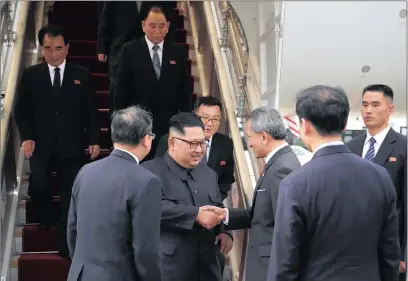  ??  ?? In this photo released by the Ministry of Communicat­ions and Informatio­n of Singapore, North Korean leader Kim Jong-un, centre, is greeted by Singapore Minister for Foreign Affairs Dr Vivian Balakrishn­an at Changi Internatio­nal Airport yesterday in Singapore before a summit with US President Donald Trump. PICTURE: MINISTRY OF COMMUNICAT­IONS AND INFORMATIO­N, SINGAPORE/AP