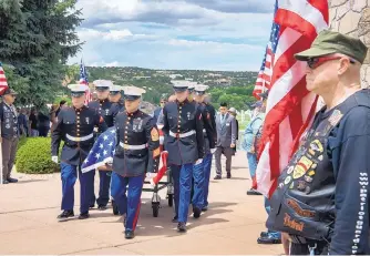  ?? EDDIE MOORE/JOURNAL ?? A Marine Corps Honor Guard carries the remains of Platoon Sgt. George E. Trotter to his burial service at the Santa Fe National Cemetery on Friday. Trotter was killed during World War II.