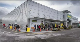  ??  ?? Big crowds lining up for Woodie’s reopening in Tralee early on Monday. Photo By Domnick Walsh