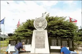  ?? Special to the Arkansas Democrat-Gazette ?? Contractor­s add names to the Little Rock Air Force Base’s High Flight Memorial last month. The monument now honors 95 airmen killed in 27 accidents.