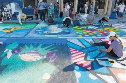  ?? JIM RASSOL/STAFF PHOTOGRAPH­ER ?? More than 600 artists used chalk as their brush and the pavement as their canvas to turn the downtown streets of Lake Worth into a temporary art gallery. The 23rd annual Lake Worth Street Painting Festival featuring food, music and free shuttles to and...