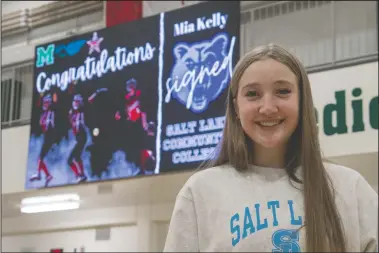  ?? NEWS PHOTO RYAN MCCRACKEN ?? Mia Kelly stands in front of a congratula­tory sign after putting pen to paper on a full scholarshi­p with the Salt Lake Community College Bruins NJCAA Division 1 softball team on Thursday at Medicine Hat High School.