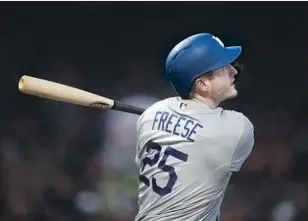  ?? Ben Margot Associated Press ?? DAVID FREESE FOLLOWS through on his three-run, opposite-field home run against San Francisco’s Drew Pomeranz in the fourth inning, giving the Dodgers a 3-1 lead.