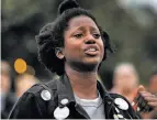  ??  ?? At the San Francisco vigil, Monique Rollocks sheds tears as she describes her experience­s with racism.