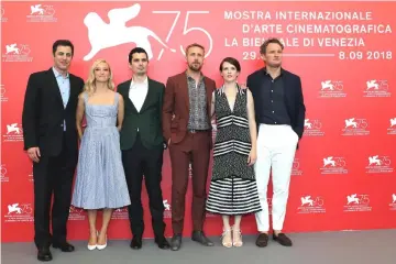  ?? — Reuters photo ?? Director Damien Chazelle (third left), screenwrit­er Josh Singer (extreme left) and cast members Ryan Gosling (third right), Jason Clarke, Olivia Hamilton and Claire Foy (second right) during a photocall for the opening movie ‘First Man’ competing in the Venezia 75 section in Venice, Italy, end of last month.