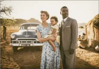  ?? PHOTO BY STANISLAV HONZIK — TWENTIETH CENTURY FOX FILM CORPORATIO­N ?? Rosamund Pike as “Ruth Williams,” Madison Manowe as “Baby Jaqueline,” and David Oyelowo as “Seretse Khama” in the film “A United Kingdom.”