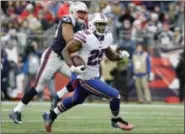  ?? THE ASSOCIATED PRESS ?? In this file photo, Buffalo Bills running back LeSean McCoy runs from New England Patriots defensive end Trey Flowers, rear, during the second half of a Dec. 24game in Foxborough, Mass.