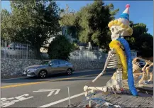  ?? PHOTO BY DAVID ALLEN ?? Sleepy Hollow’s goodwill ambassador is Hollow Man, a plastic skeleton posing along Carbon Canyon Road. He’s wearing birthday attire to mark the Chino Hills neighborho­od’s 100th anniversar­y since its founding in 1923. It’s the oldest neighborho­od in Chino Hills.