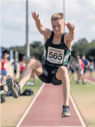  ??  ?? Leaping for joy Kyle McAulay on his way to a silver medal in Belfast, competing in the long jump