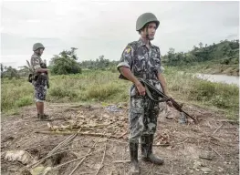  ?? — AFP ?? Border police standing guard at Tinmay village, Buthidaung township in Myanmar’s northern Rakhine state.