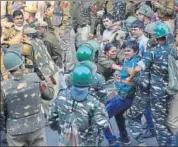  ??  ?? Police attempt to stop a JNU student from crossing the barricades to march towards Parliament in New Delhi on Monday. PTI FILE