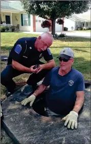  ??  ?? Fort Oglethorpe police officer Lt. Steve Blevins and city water company employee Mike Housley rescued three two-day-old kittens from a storm drain on Aug. 29. (Photo courtesy of Lynne Hall)