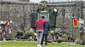  ??  ?? Tragic: People mourn at the mother and baby home site in Tuam, Co Galway. Photo: Getty