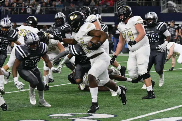  ?? Photo by Kevin Sutton ?? Pleasant Grove running back T.J. Cole stiff-arms a West Orange-Stark defender Friday during the Class 4A, Division II state championsh­ip game at AT&T Stadium in Arlington, Texas. Cole finished with 81 yards rushing, 107 yards receiving and three...